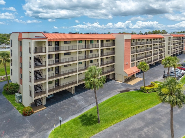 9450 Harbor Greens Way Unit 207, Seminole, FL 33776 - view of apartment building / complex with uncovered parking
