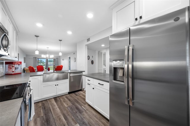 9450 Harbor Greens Way Unit 207, Seminole, FL 33776 - kitchen with stainless steel appliances, dark wood-style flooring, a peninsula, white cabinetry, and recessed lighting