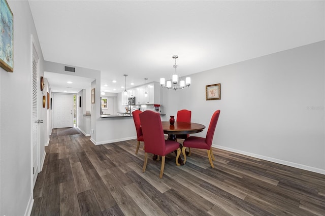 9450 Harbor Greens Way Unit 207, Seminole, FL 33776 - dining space with a chandelier, dark wood finished floors, baseboards, and recessed lighting