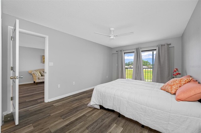 9450 Harbor Greens Way Unit 207, Seminole, FL 33776 - bedroom with access to outside, wood finished floors, baseboards, and a ceiling fan