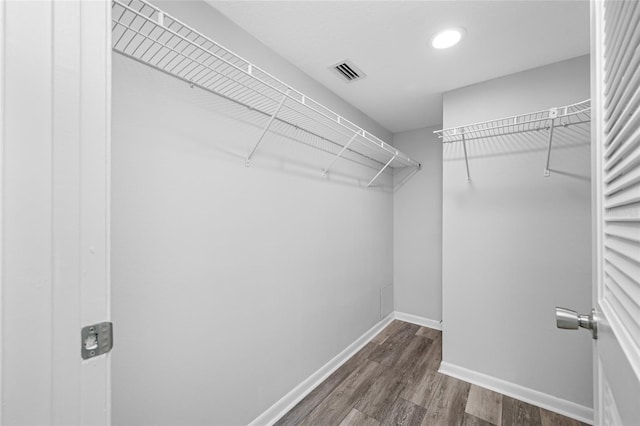 9450 Harbor Greens Way Unit 207, Seminole, FL 33776 - walk in closet featuring dark wood-style flooring