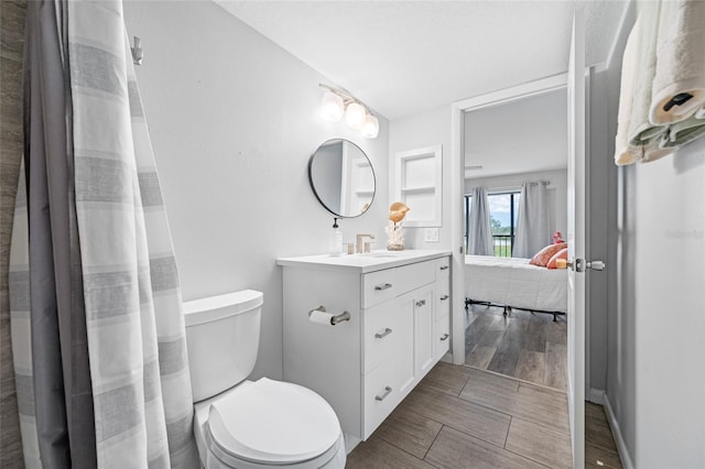 9450 Harbor Greens Way Unit 207, Seminole, FL 33776 - full bathroom with vanity, toilet, and wood finished floors