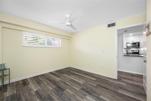 9450 Harbor Greens Way Unit 207, Seminole, FL 33776 - unfurnished room with ceiling fan, dark wood-type flooring, and baseboards