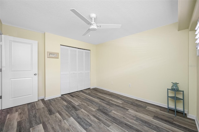 9450 Harbor Greens Way Unit 207, Seminole, FL 33776 - unfurnished bedroom featuring dark wood-style floors, a closet, baseboards, and ceiling fan