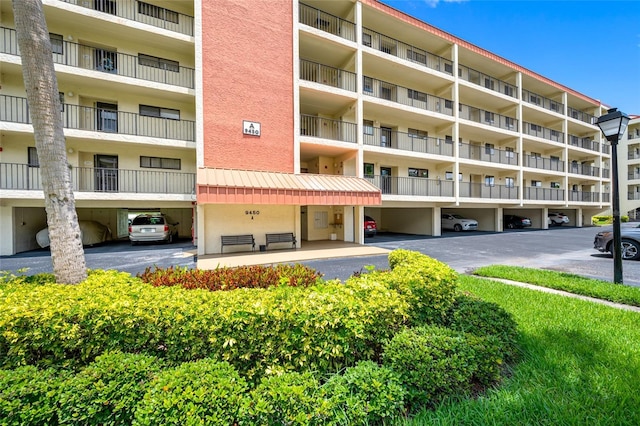 9450 Harbor Greens Way Unit 207, Seminole, FL 33776 - view of apartment building / complex with covered parking