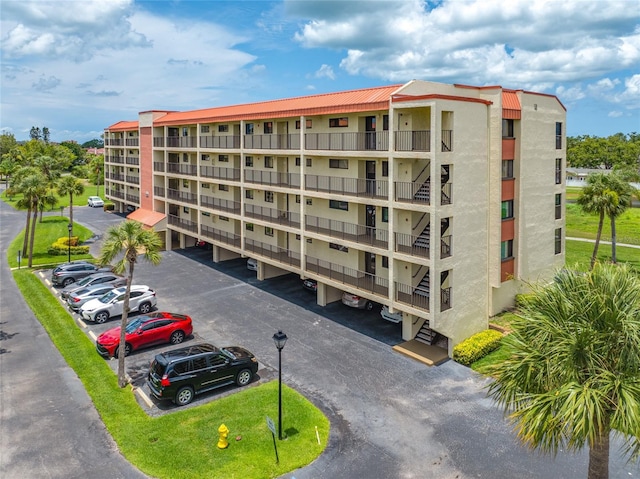 9450 Harbor Greens Way Unit 207, Seminole, FL 33776 - view of apartment building / complex with uncovered parking