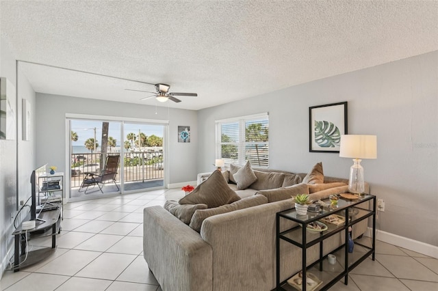 14401 Gulf Blvd Unit 106, Madeira Beach, FL 33708 - living room featuring a ceiling fan, light tile patterned floors, a textured ceiling, and baseboards