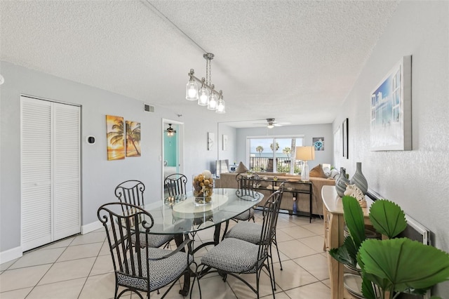 14401 Gulf Blvd Unit 106, Madeira Beach, FL 33708 - dining area with a ceiling fan, light tile patterned floors, and a textured ceiling