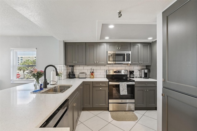 14401 Gulf Blvd Unit 106, Madeira Beach, FL 33708 - kitchen featuring appliances with stainless steel finishes, a sink, decorative backsplash, light tile patterned floors, and recessed lighting