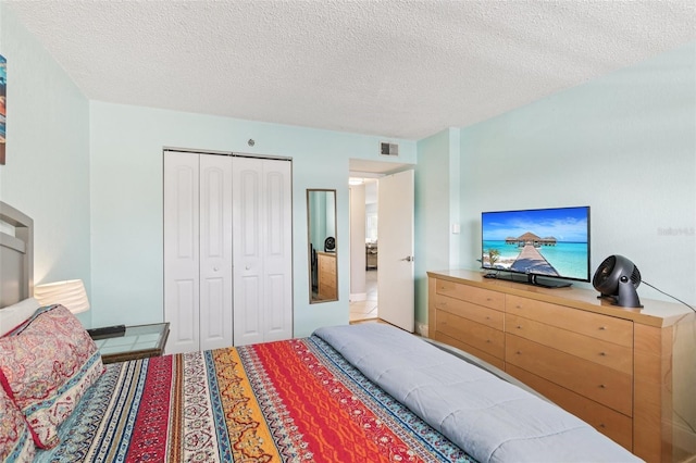 14401 Gulf Blvd Unit 106, Madeira Beach, FL 33708 - bedroom featuring a closet and a textured ceiling