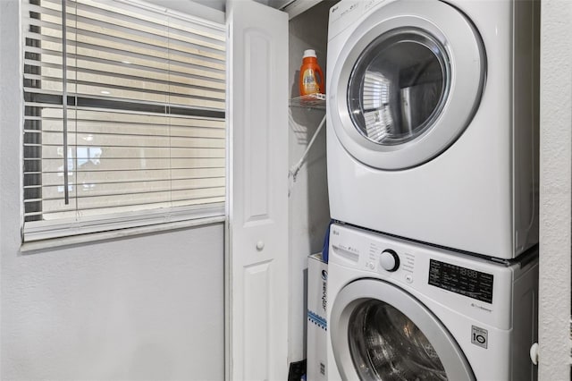 14401 Gulf Blvd Unit 106, Madeira Beach, FL 33708 - washroom featuring stacked washer and clothes dryer
