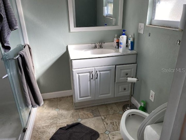 3512 16th St E, Bradenton, FL 34208 - bathroom featuring vanity, toilet, baseboards, and an enclosed shower