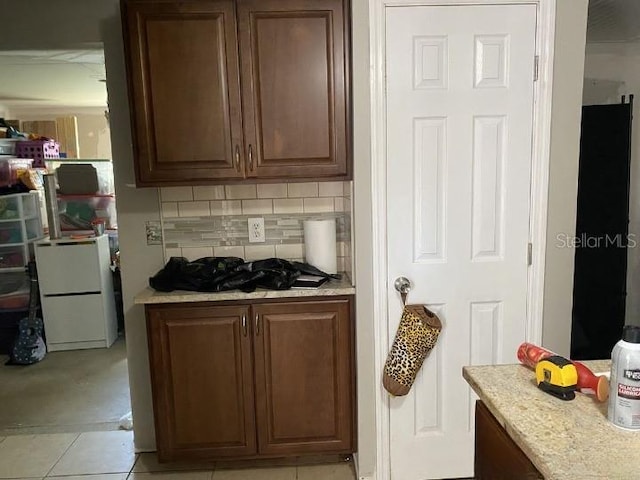 3512 16th St E, Bradenton, FL 34208 - kitchen with light countertops, tasteful backsplash, and light tile patterned floors