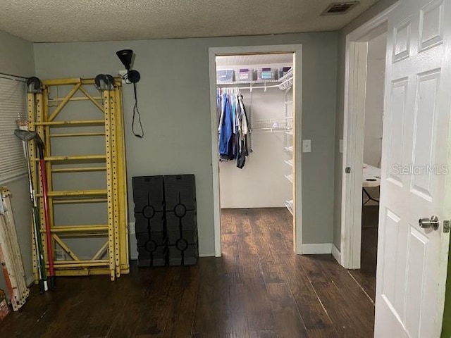 3512 16th St E, Bradenton, FL 34208 - bedroom with wood finished floors, a walk in closet, a closet, and baseboards