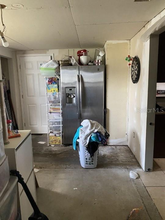 3512 16th St E, Bradenton, FL 34208 - kitchen with stainless steel fridge with ice dispenser and unfinished concrete flooring