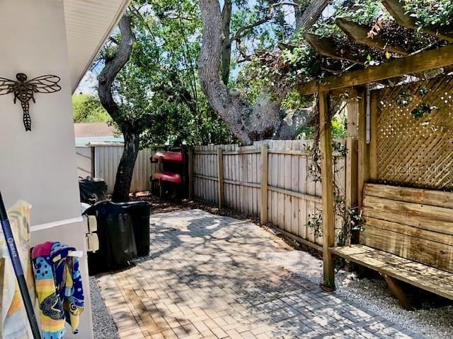 14530 Apache Ave, Largo, FL 33774 - fenced backyard featuring a patio and a pergola