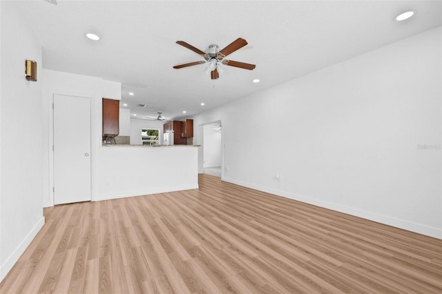 5326 22nd Ave N, Saint Petersburg, FL 33710 - unfurnished living room featuring a ceiling fan, light wood-type flooring, recessed lighting, and baseboards