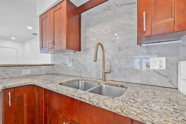 5326 22nd Ave N, Saint Petersburg, FL 33710 - kitchen featuring a sink, decorative backsplash, light stone counters, reddish brown cabinets, and recessed lighting