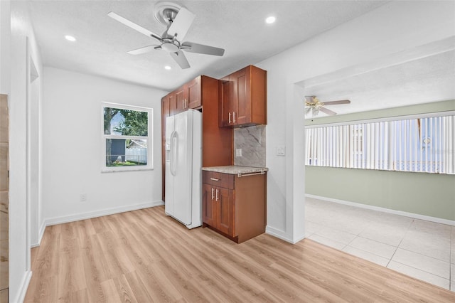 5326 22nd Ave N, Saint Petersburg, FL 33710 - kitchen featuring white fridge with ice dispenser, a ceiling fan, light wood-style flooring, decorative backsplash, and recessed lighting