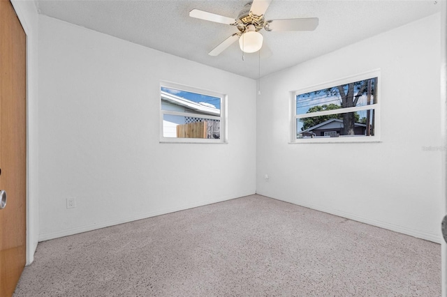 5326 22nd Ave N, Saint Petersburg, FL 33710 - spare room featuring speckle patterned floor, baseboards, a ceiling fan, and a textured ceiling