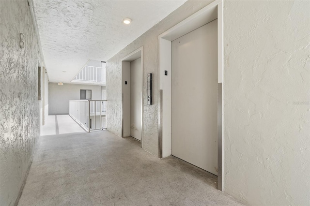 500 N Osceola Ave Unit 811, Clearwater, FL 33755 - hall with elevator, concrete floors, a textured wall, and a textured ceiling