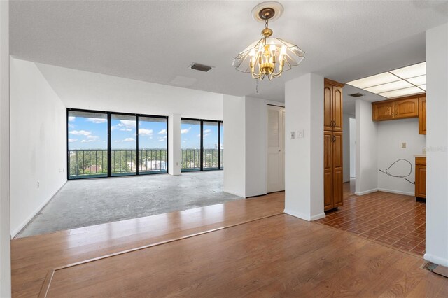 500 N Osceola Ave Unit 811, Clearwater, FL 33755 - unfurnished living room with a chandelier and baseboards