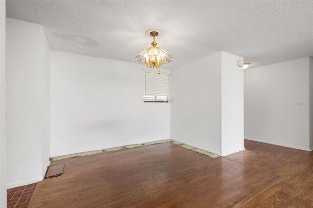 500 N Osceola Ave Unit 811, Clearwater, FL 33755 - spare room featuring a chandelier, wood finished floors, and a textured ceiling