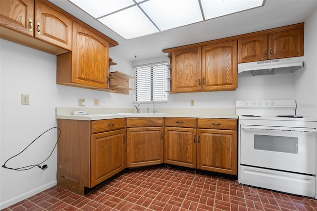 500 N Osceola Ave Unit 811, Clearwater, FL 33755 - kitchen with white range with electric stovetop, under cabinet range hood, brick patterned floors, a sink, and light countertops