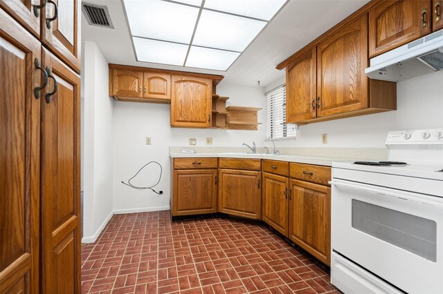 500 N Osceola Ave Unit 811, Clearwater, FL 33755 - kitchen featuring white electric range, under cabinet range hood, brick patterned flooring, and brown cabinetry