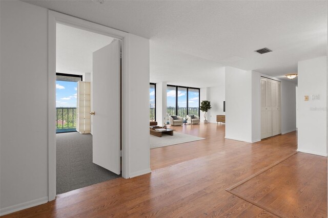 500 N Osceola Ave Unit 811, Clearwater, FL 33755 - empty room with expansive windows and wood finished floors