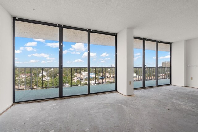 500 N Osceola Ave Unit 811, Clearwater, FL 33755 - spare room featuring a wall of windows, a textured ceiling, and unfinished concrete flooring