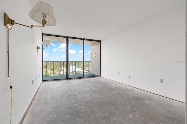 500 N Osceola Ave Unit 811, Clearwater, FL 33755 - spare room featuring a wall of windows, concrete floors, and baseboards