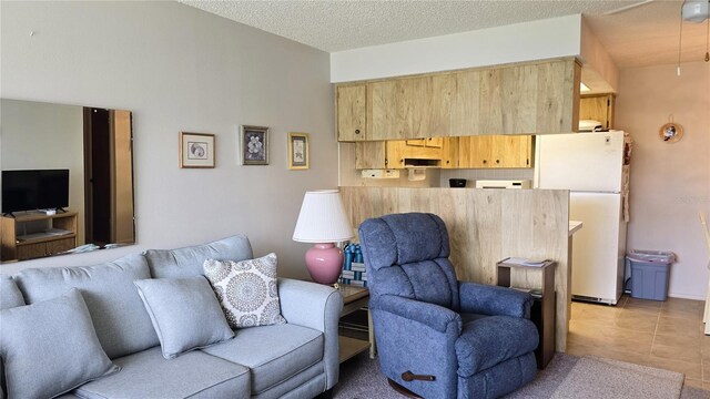 4324 Tahitian Gardens Cir Unit J, Holiday, FL 34691 - living area with light tile patterned floors and a textured ceiling