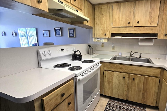 4324 Tahitian Gardens Cir Unit J, Holiday, FL 34691 - kitchen featuring white electric stove, under cabinet range hood, a sink, light countertops, and decorative backsplash