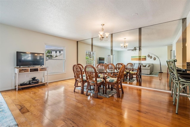 2700 Bayshore Blvd Unit 497, Dunedin, FL 34698 - dining area featuring a chandelier, light wood-type flooring, and a textured ceiling