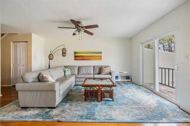 2700 Bayshore Blvd Unit 497, Dunedin, FL 34698 - living area featuring wood finished floors, a ceiling fan, a textured ceiling, and baseboards