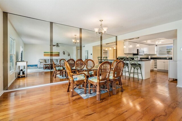2700 Bayshore Blvd Unit 497, Dunedin, FL 34698 - dining area with a chandelier, light wood-style floors, and ceiling fan