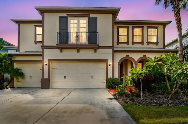 4089 Windcrest Dr, Wesley Chapel, FL 33544 - view of front facade featuring a balcony, stucco siding, a garage, and concrete driveway