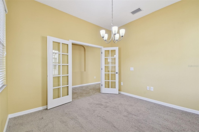 4089 Windcrest Dr, Wesley Chapel, FL 33544 - empty room featuring french doors, carpet flooring, a chandelier, and baseboards