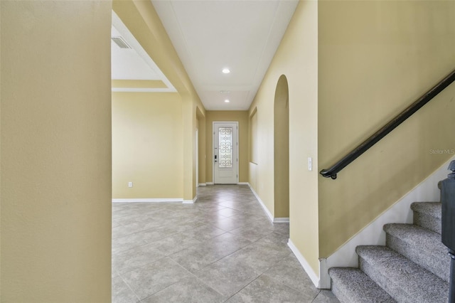 4089 Windcrest Dr, Wesley Chapel, FL 33544 - foyer with arched walkways, baseboards, stairs, light tile patterned floors, and recessed lighting