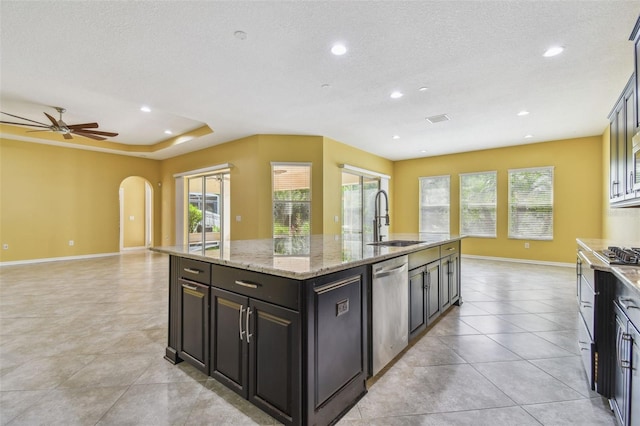 4089 Windcrest Dr, Wesley Chapel, FL 33544 - kitchen with a sink, appliances with stainless steel finishes, a kitchen island with sink, arched walkways, and recessed lighting
