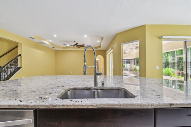 4089 Windcrest Dr, Wesley Chapel, FL 33544 - kitchen featuring a sink, a ceiling fan, recessed lighting, light stone countertops, and arched walkways