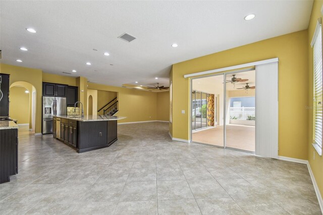 4089 Windcrest Dr, Wesley Chapel, FL 33544 - kitchen featuring stainless steel fridge with ice dispenser, arched walkways, open floor plan, a ceiling fan, and recessed lighting