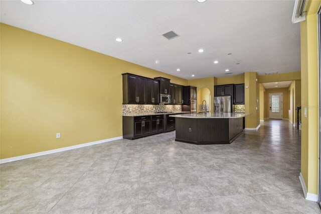 4089 Windcrest Dr, Wesley Chapel, FL 33544 - kitchen with stainless steel appliances, light countertops, open floor plan, baseboards, and recessed lighting