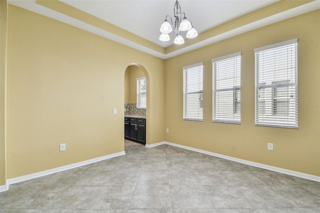 4089 Windcrest Dr, Wesley Chapel, FL 33544 - unfurnished room featuring a chandelier, arched walkways, and baseboards