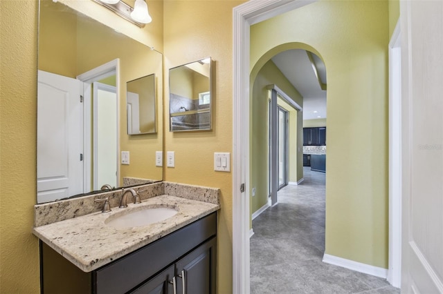 4089 Windcrest Dr, Wesley Chapel, FL 33544 - bathroom with vanity, baseboards, a textured wall, and concrete floors
