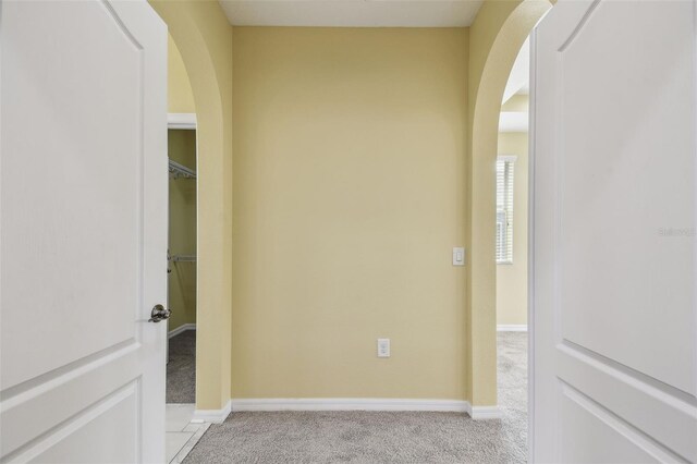 4089 Windcrest Dr, Wesley Chapel, FL 33544 - hallway with arched walkways, carpet, and baseboards