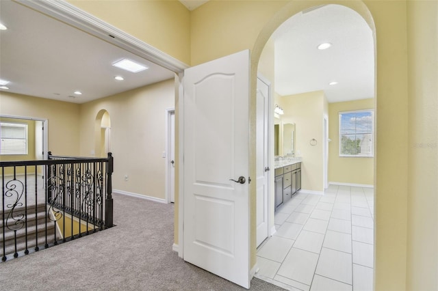 4089 Windcrest Dr, Wesley Chapel, FL 33544 - hall featuring an upstairs landing, arched walkways, recessed lighting, baseboards, and a sink