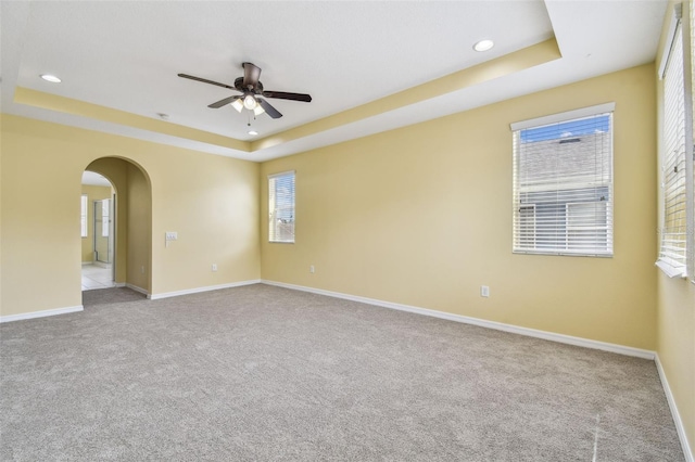 4089 Windcrest Dr, Wesley Chapel, FL 33544 - carpeted spare room with a tray ceiling, ceiling fan, baseboards, arched walkways, and recessed lighting