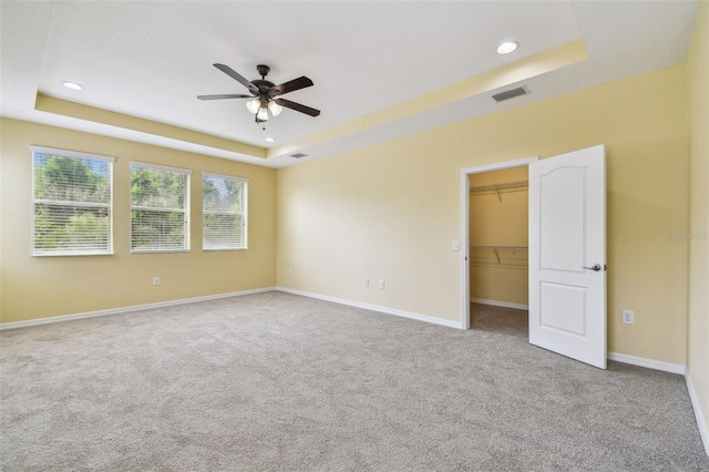 4089 Windcrest Dr, Wesley Chapel, FL 33544 - unfurnished bedroom featuring a raised ceiling, carpet, recessed lighting, a spacious closet, and baseboards